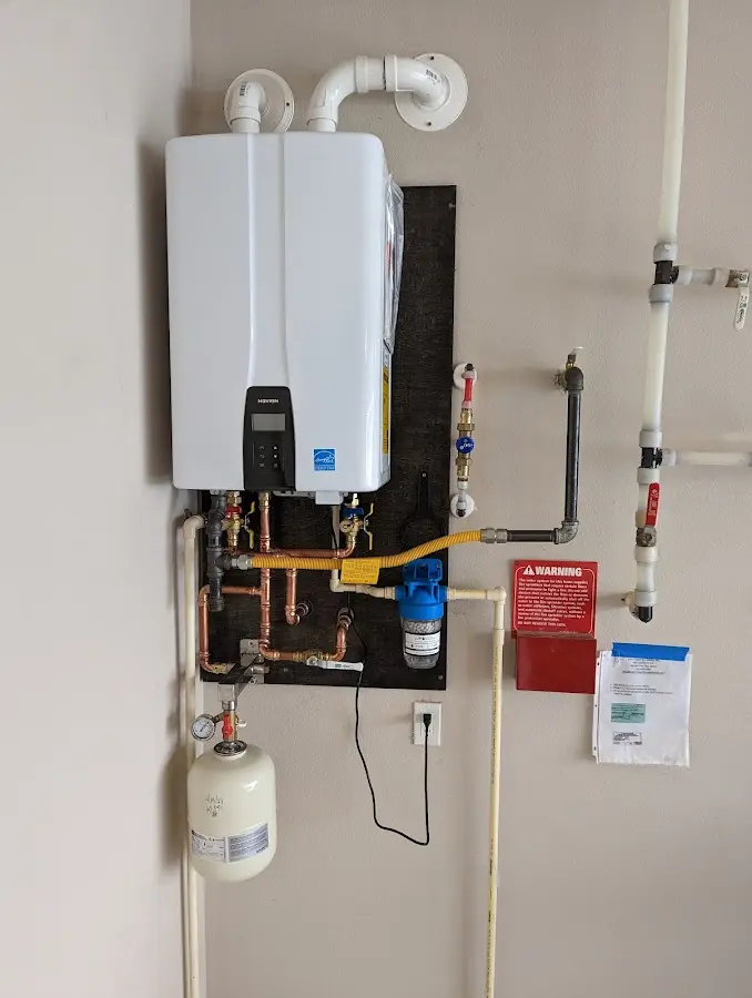 Professional plumber installing copper piping in a Crozet home